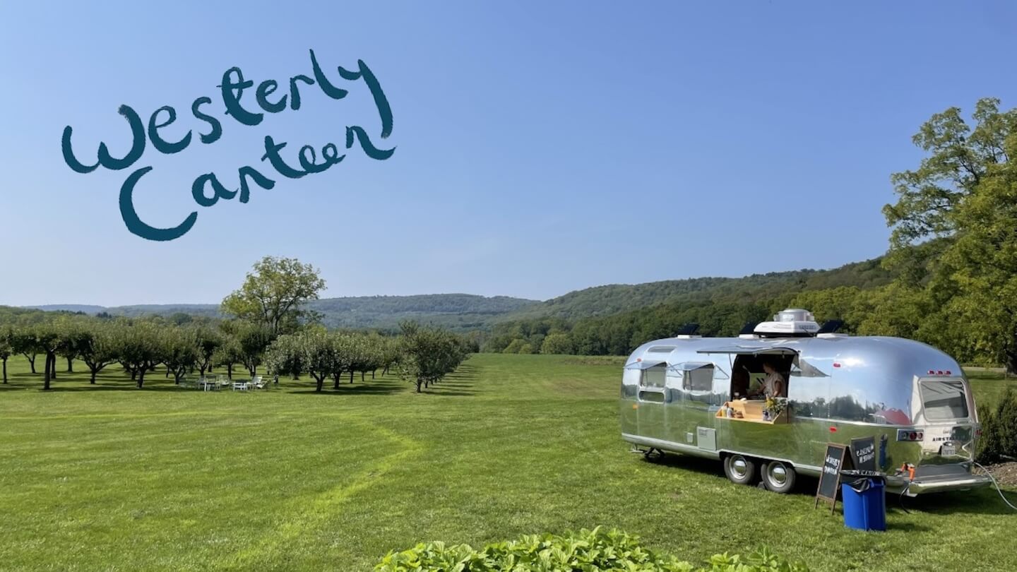 an airstream trailer in an orchard